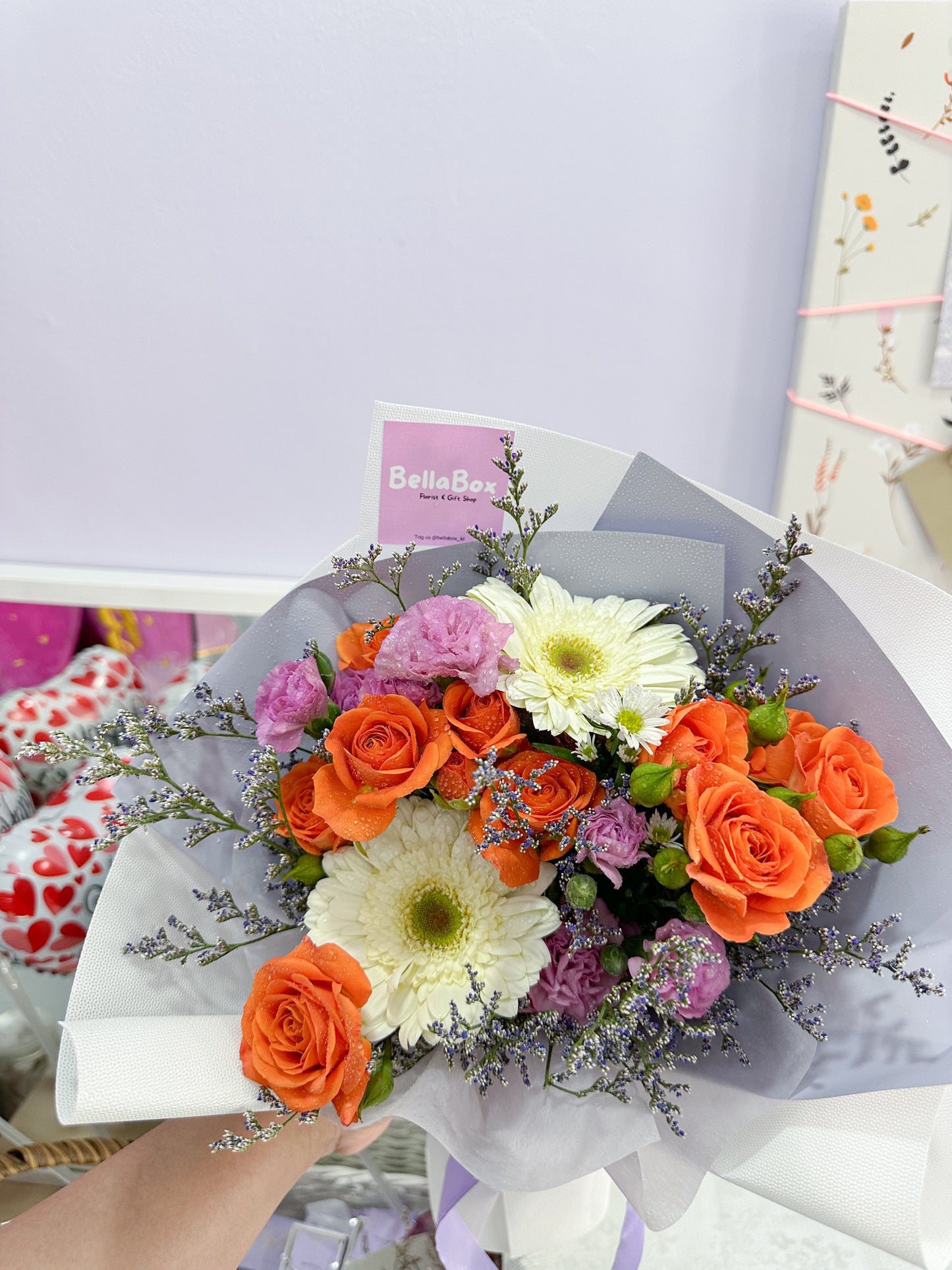 fresh orange roses, white daisy,purple carnation & caspia