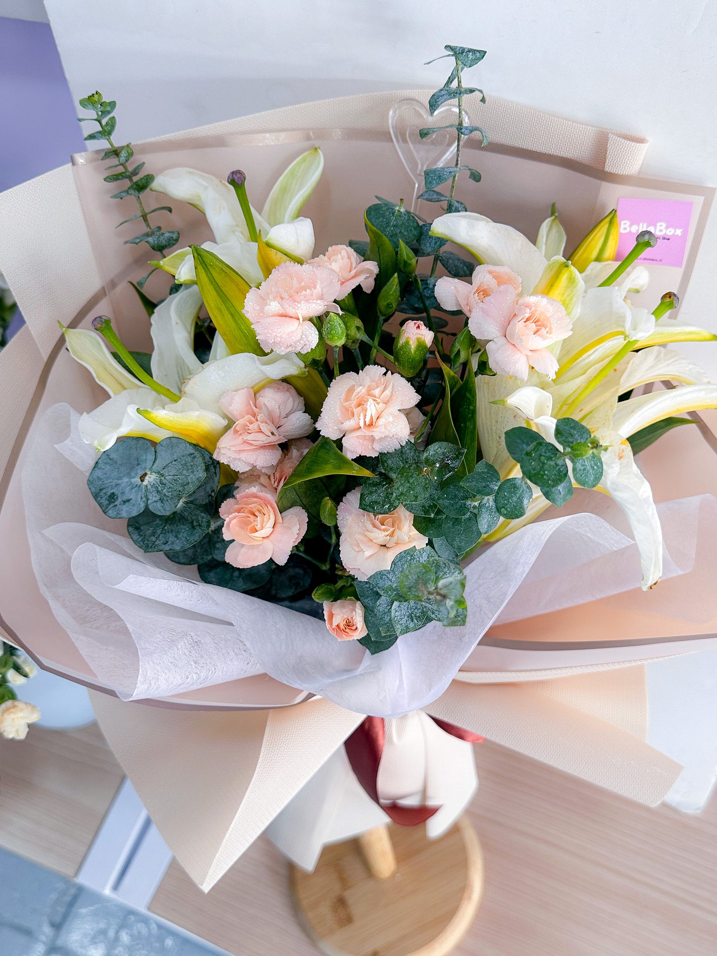 White lily with peach carnations & eucalayptus