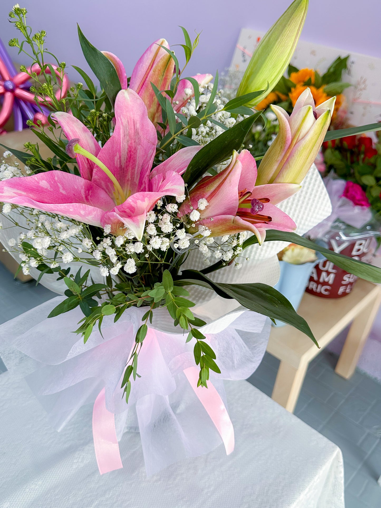 Pink Lily with baby breath, Eucalayptus in vaseu