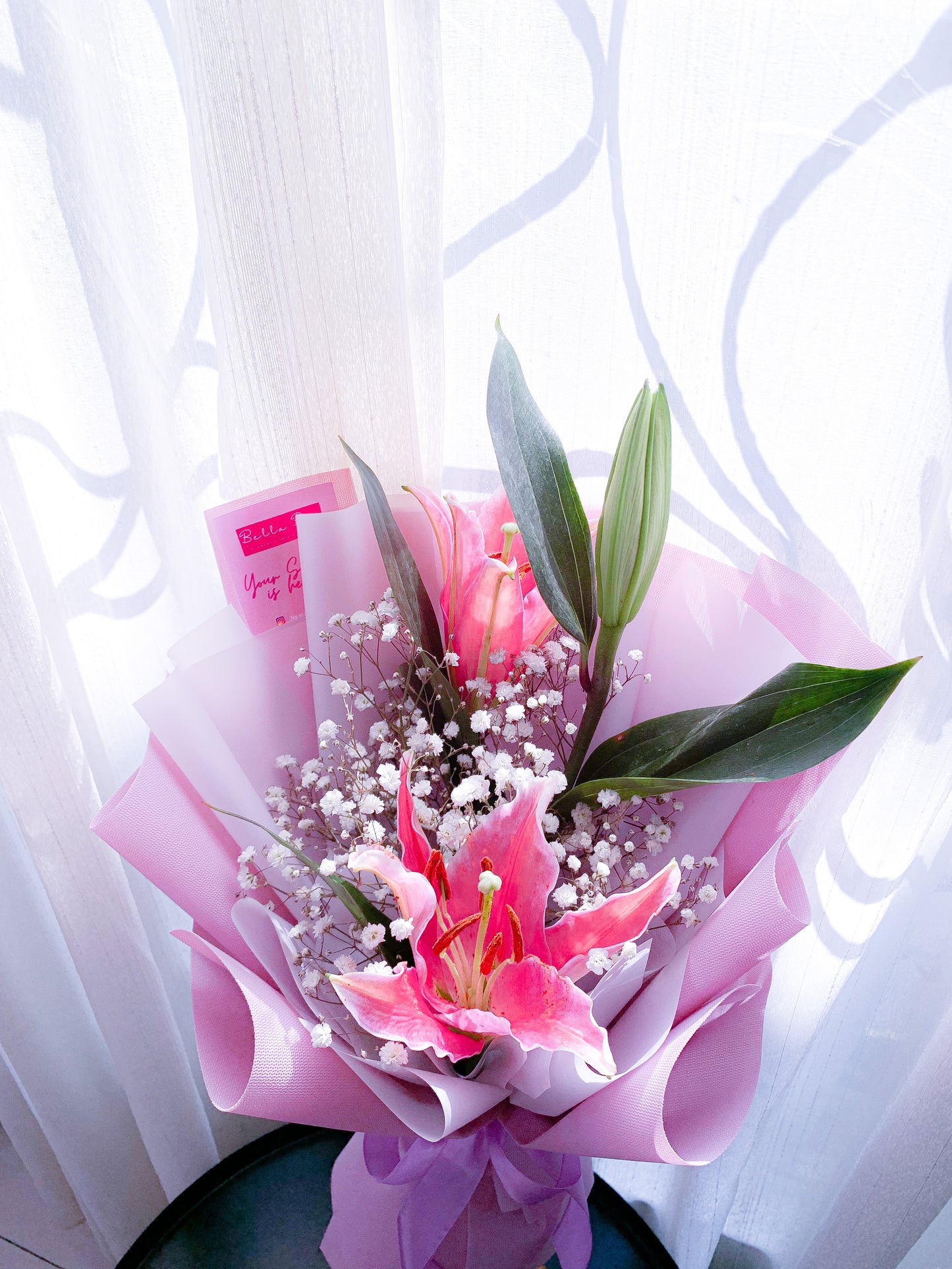 Pink lily with white baby breath