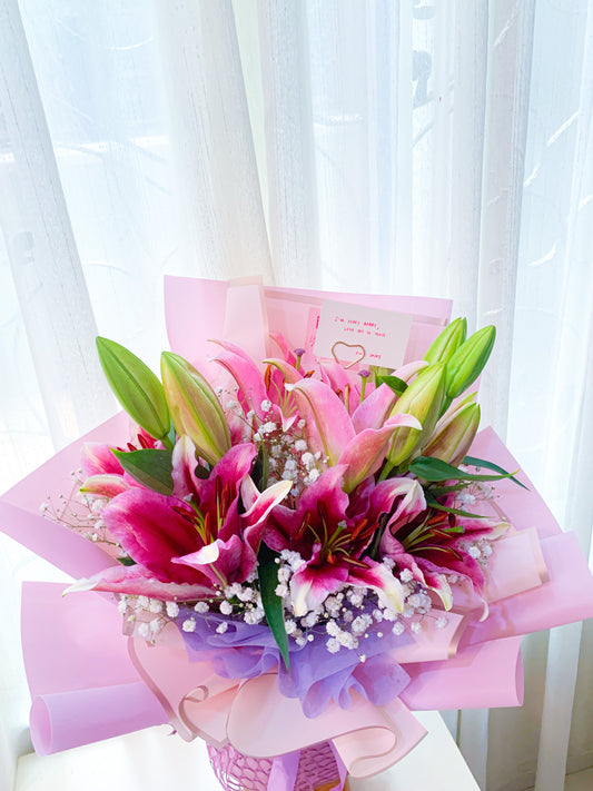 Pink lily with white baby breath